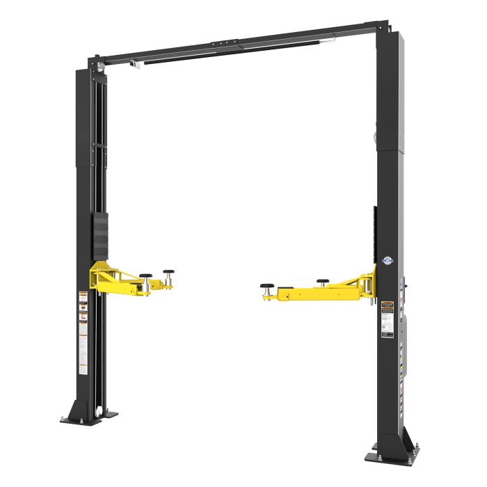 Two-post automotive lift installed in a vehicle service bay